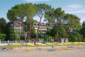 a bunch of umbrellas and chairs on a beach at HVD Lotos Hotel in Golden Sands
