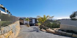 a stone retaining wall next to a street at Alvorada Premium by Sunny Deluxe in Albufeira