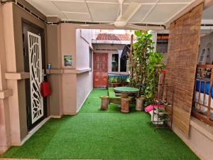 a corridor of a house with green grass at Homestay LaNik Saujana Utama 2 in Sungai Buluh