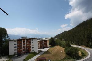 a view of a building and a road with a mountain at Choucas A16 in Crans-Montana