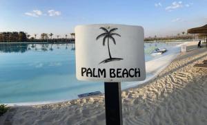 a sign on a beach with a palm tree on it at The Blyde Crystal lagoon, Pretoria (2 beds) in Pretoria
