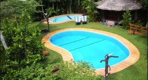 a swimming pool in the yard of a resort at Dalmanuta Gardens in Bentota