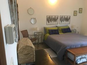 a bedroom with a bed and a chair and a tv at Azienda Agrituristica Santissima Trinità in Budrio