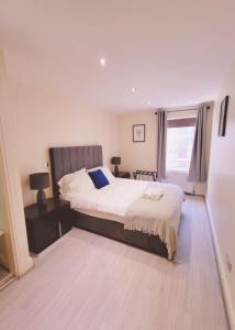 a bedroom with a large bed and a window at Central City Apartment - Free Parking in Belfast