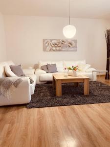 a living room with a couch and a coffee table at Trio Apartments in Ostrava