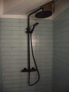 a shower with a shower head in a bathroom at Penamacor Cozy Nook House in Penamacor +20 photos