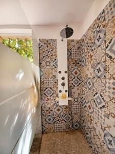 a bathroom with mosaic tiles on the wall at Studio avec jardin entre Aix-en-Provence, Luberon et Verdon in Peyrolles-en-Provence