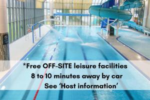 a swimming pool with a slide in a building at Crylla Valley Cottages in Saltash