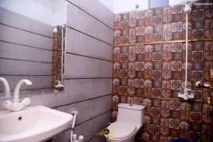 a bathroom with a toilet and a sink at Hotel Inn Hyderabad in Hyderabad +22 photos