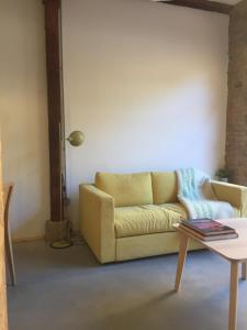 a living room with a couch and a table at Suites La Catedral in León