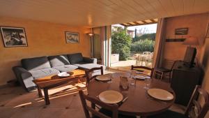 a living room with a table and a couch at Mas des Pins in La Nartelle +21 photos
