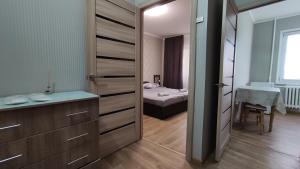 a bathroom with a door leading to a bedroom at Василя Стуса 10/77 City Rooms in Bila Tserkva