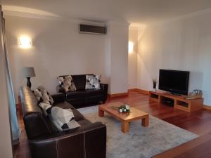a living room with a couch and a coffee table at Albufeira Modern with pool by Homing in Albufeira