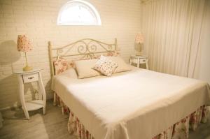 a bedroom with a bed with two tables and two lamps at Lambert in Berehove