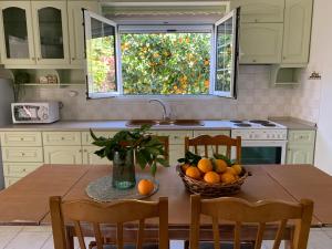 a kitchen with a table with a bowl of oranges on it at EY House in Halikounas