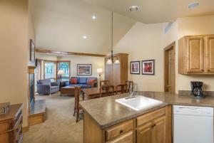 a kitchen with a sink and a living room at WorldMark Galena in Galena