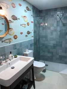 a bathroom with a sink and a toilet and a shower at "Aqui se vive bien" in Burriana +15 photos