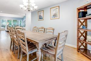a dining room with a wooden table and chairs at Baywood Luxury in Seabrook Island