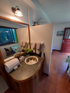 a bathroom with a sink and a mirror at Casa Costa Rica Boutique B&B in Pilas
