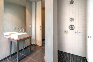 a bathroom with a sink and a shower at The Hendrik House in Old Town Antwerp in Antwerp