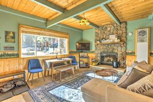 a living room with a couch and a fireplace at Cozy Big Bear Lake Cabin about 1 Mi to Skiing! in Big Bear Lake