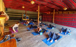 a group of people doing yoga in a stage at Selina Desert Garden Ramon in Mitzpe Ramon