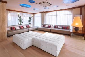 a living room with a white couch and a table at Mònica Hotel in Cambrils