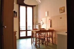 a kitchen with a table and chairs in a room at Lombardi Ramazzini in Parma