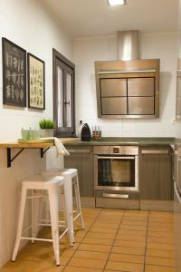 a kitchen with a counter and a stove top oven at Apartamento Palacio Descalzos in Tudela