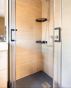 a shower with a glass door in a bathroom at Appartement T2- Le bon accueil / WIFI / PARKING in Angoulême
