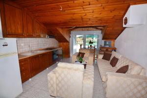 a living room with two couches and a kitchen at Effi's Garden Villa in Limenas