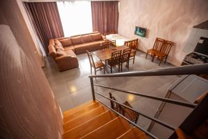 a living room with a couch and a table and chairs at Green Hills in Bakuriani