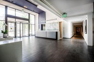 a large room with a kitchen and a large window at 2500 Penn, a Placemakr Experience in Washington, D.C.