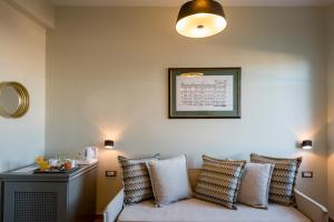 a living room with a couch and pillows at Leto Nuevo Hotel in Nafplio