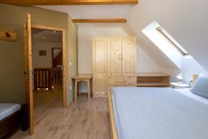 a bedroom with a large bed and a staircase at Chalet Pr Dobravc in Bohinj