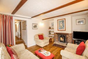 a living room with a couch and a fireplace at Cajun Cottage in Wareham