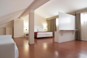 a hotel room with a bed and a room with at Hotel Tourist in Turin