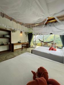 a bedroom with two beds and a large window at Zion View Ella Green Retreat in Ella