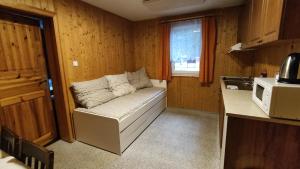 a small room with a couch in a kitchen at Penzion apartmány Aninka in Mariánská