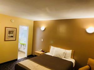 Postel nebo postele na pokoji v ubytování M Star Hotel Mansfield