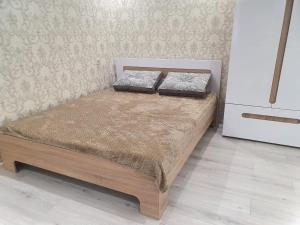 a bed with two pillows on it in a room at Квартира in Gagra