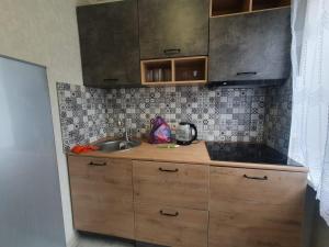 a kitchen with a sink and a counter top at Квартира in Gagra