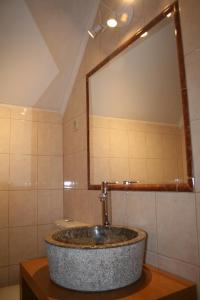 a sink in a bathroom with a large mirror at Murtosa House in Torreira