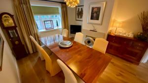 a dining room with a wooden table and chairs at Keepers Lodge in Swithland