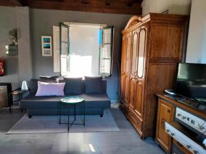 a living room with a couch and a tv at Errekaondo in Areatza