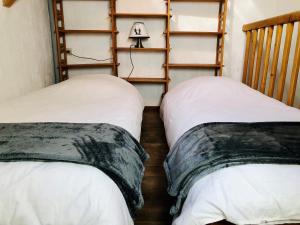 מיטה או מיטות בחדר ב-Gîte La Grange au Bois