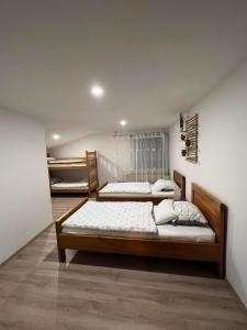 two beds are in a room with at apartma "happy Scotts" in Starše +67 photos