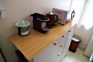 a counter with a coffee maker and a microwave on it at Hoche Cannes Centre "Palais - Croisette - Beach" in Cannes