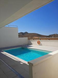 a swimming pool on the roof of a house at Luz del Cabo in El Pozo de los Frailes