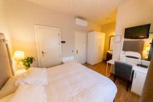 Postel nebo postele na pokoji v ubytování Hotel Viscardo